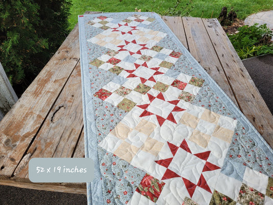 Large ice blue Christmas Table Runner shown outdoors on a weathered wooden table.