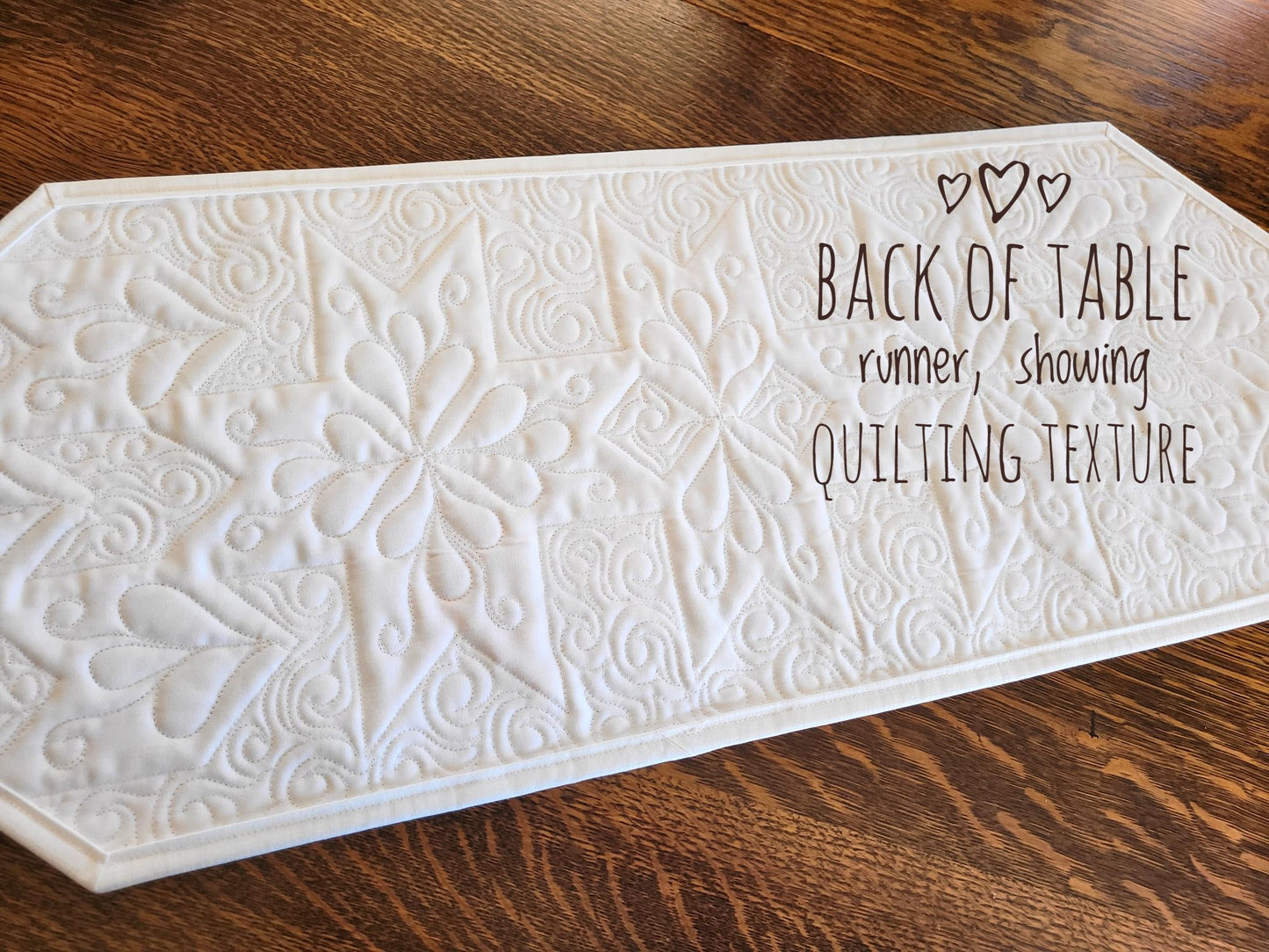 Spring tulip table runner quilt, showing back side and quilting texture.