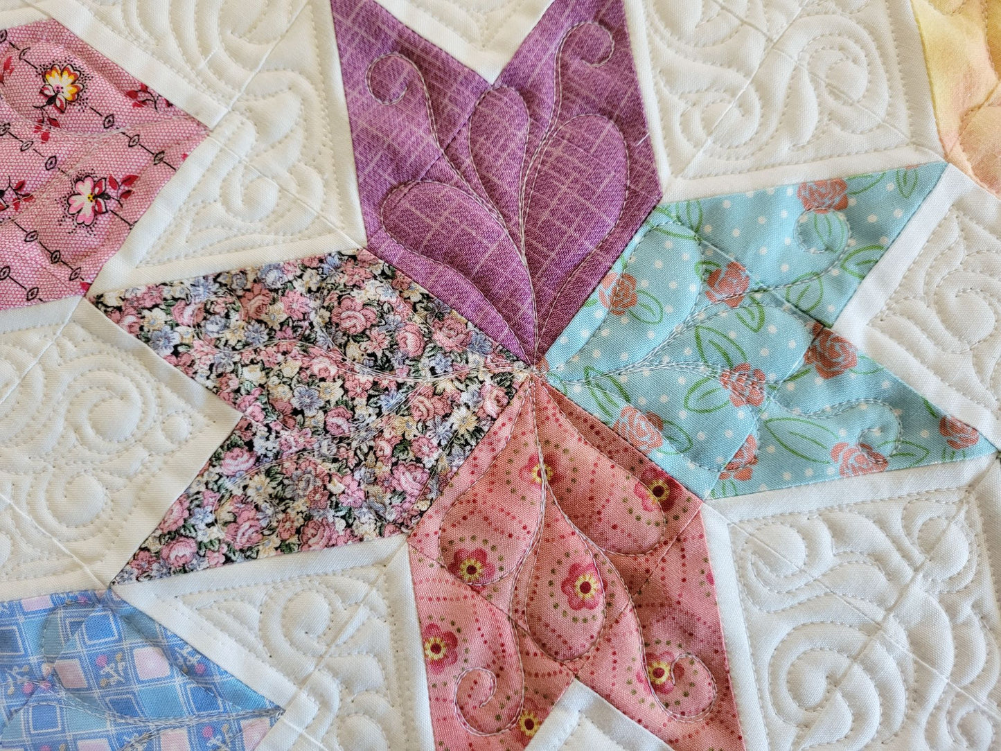 Spring tulip table runner in pastel patchwork on white background, shown in close up.