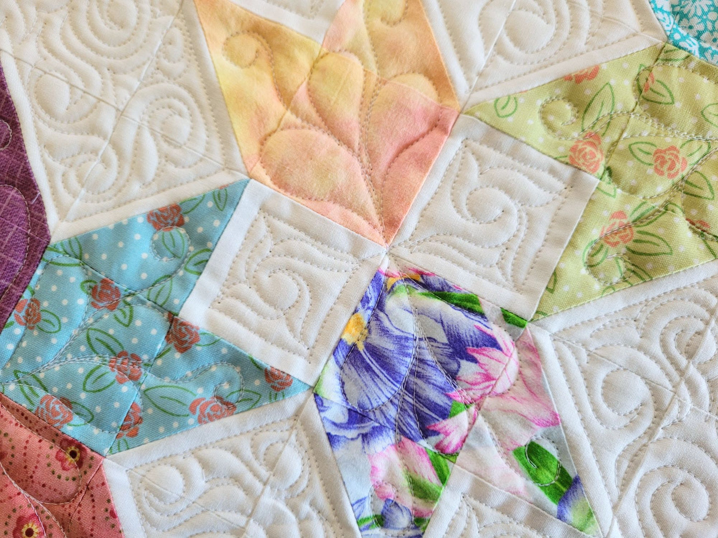 Spring tulip table runner in pastel patchwork on white background, shown in close up.
