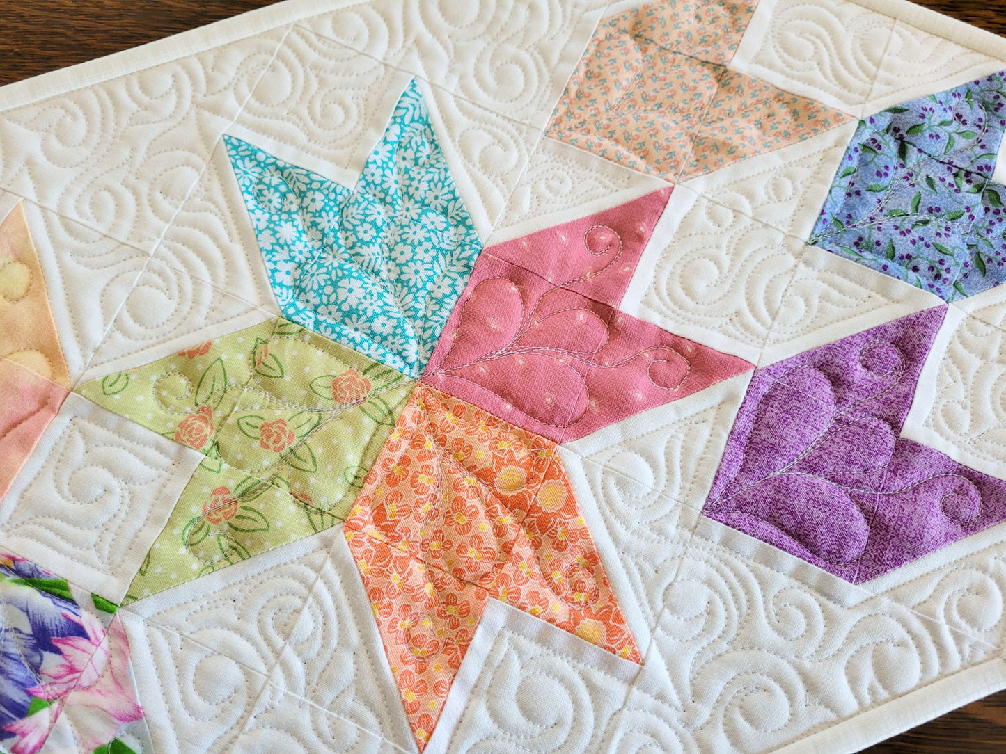 Spring tulip table runner in pastel patchwork on white background, shown in close up.
