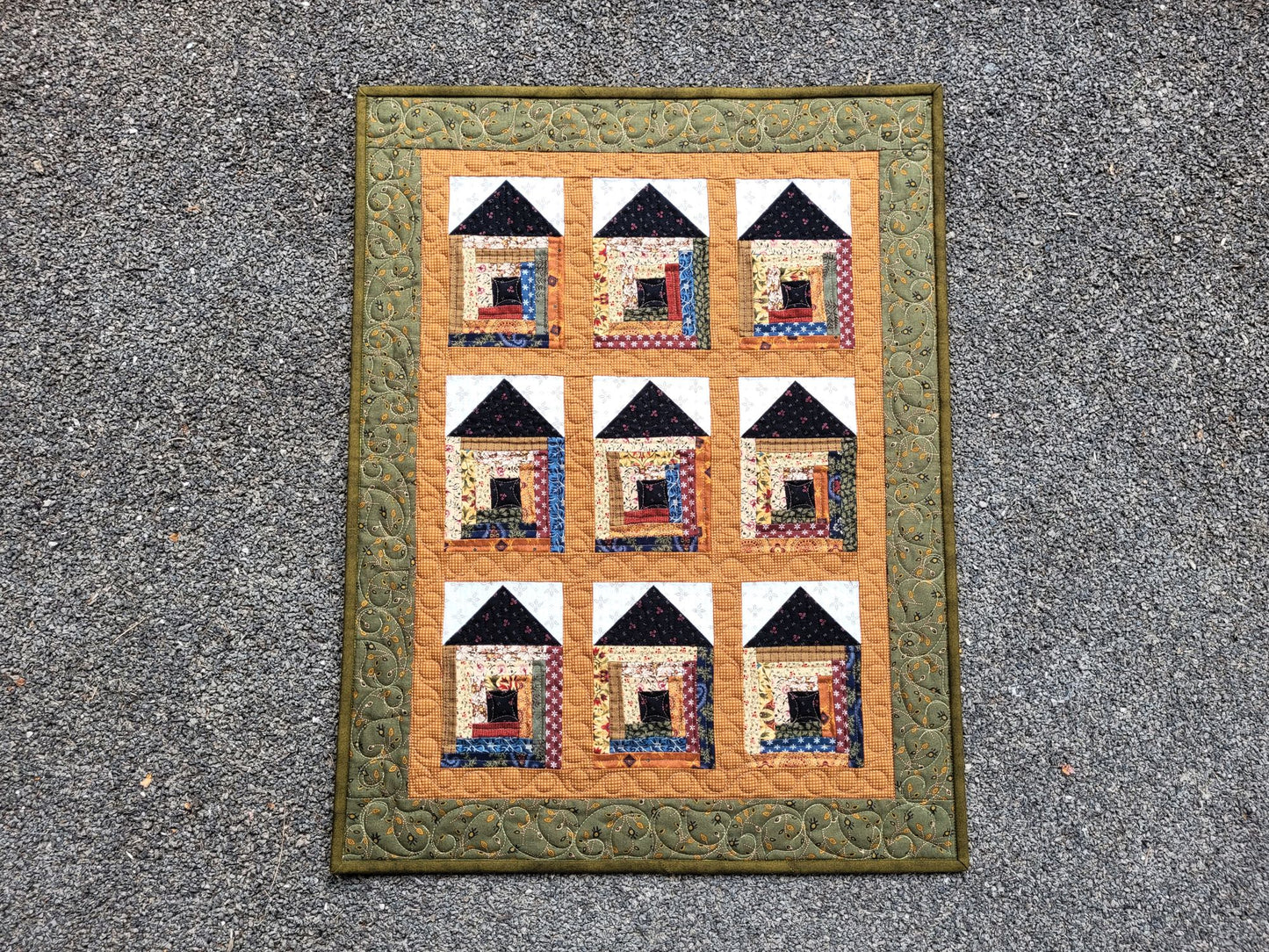 Quilt with house pattern on a textured surface