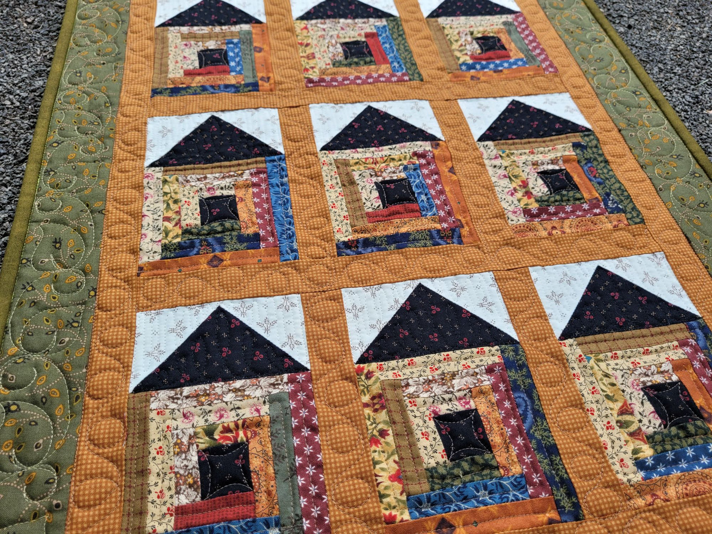 Quilt with house pattern on a textured surface