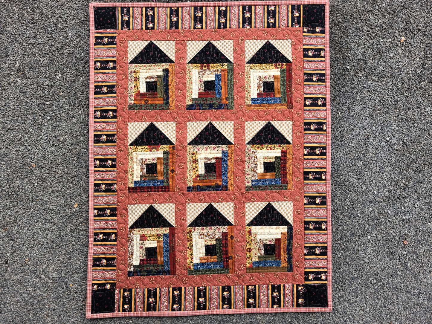 Quilt with house pattern on a textured surface