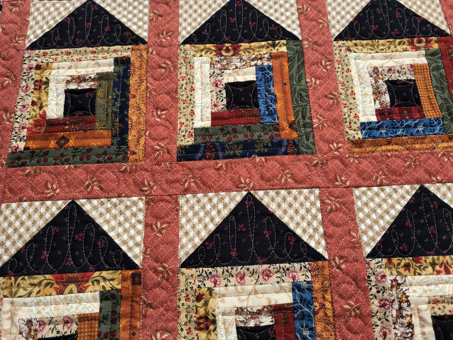 Quilt with patchwork design featuring various colors and patterns
