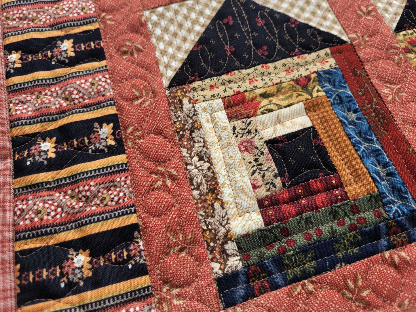 Close-up of a patchwork quilt with various patterns and colors.
