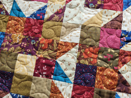 Patchwork quilt with multicolored fabric squares
