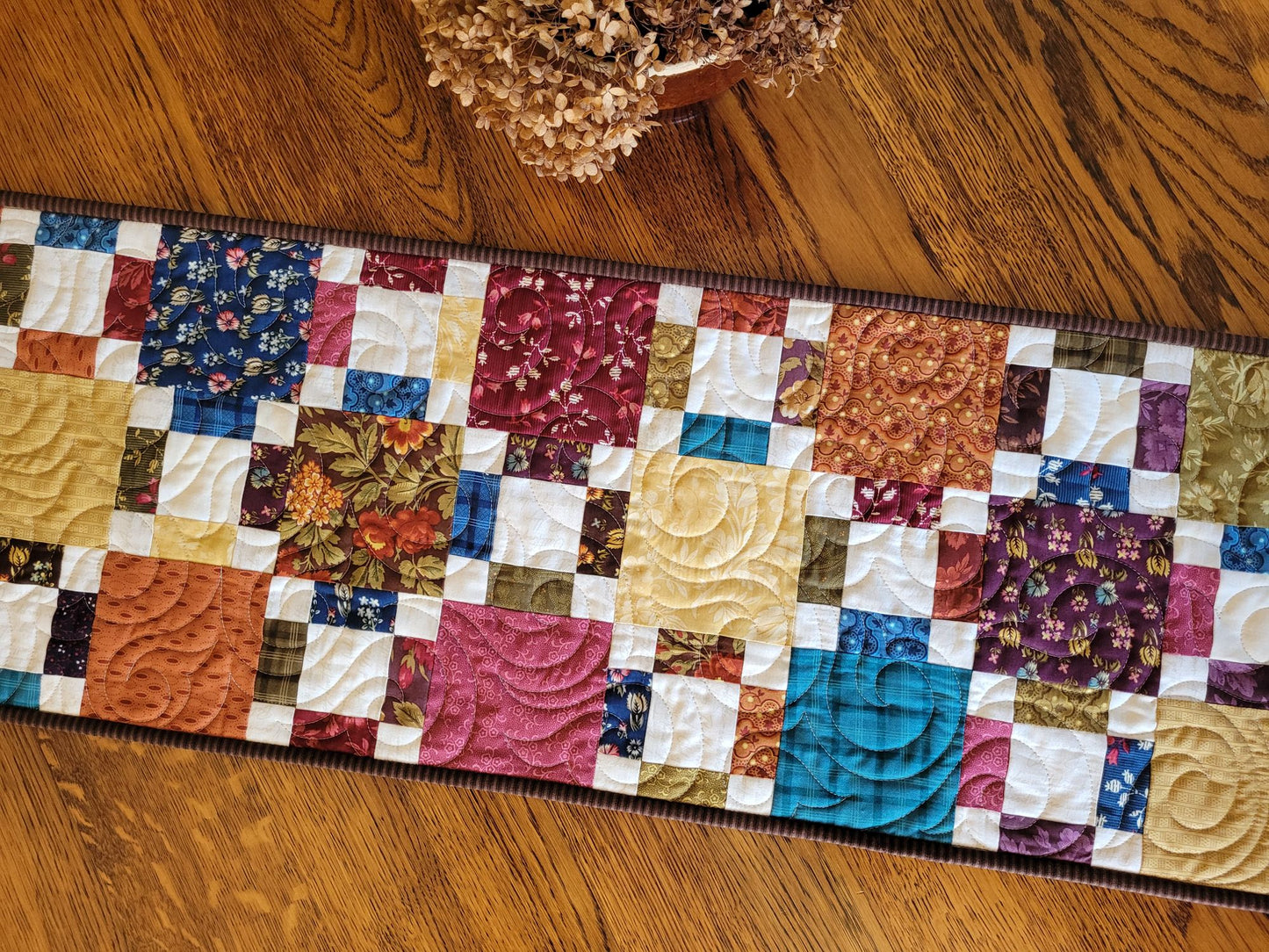 Colourful patchwork quilt on a wooden table
