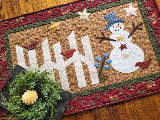 Applique snowman scene with rail fence, stars and three red birds in rustic traditional colours.