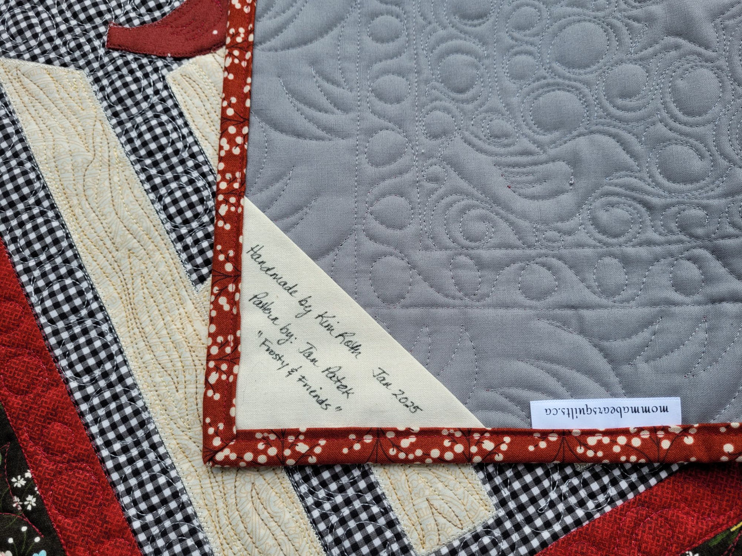 Showing handmade quilt label on back of quilt.