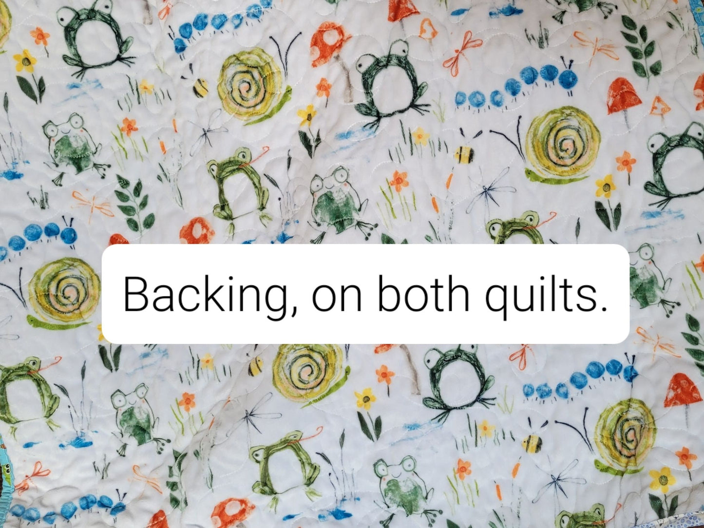 soft minky backing with frogs, snails, mushrooms, caterpillars, bees, flowers, grass, leaves