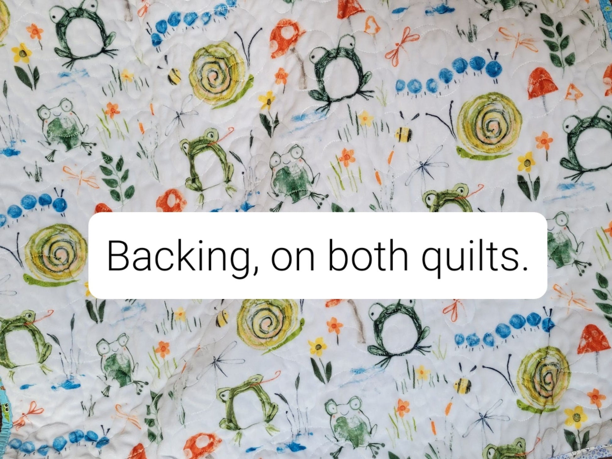 soft minky backing with frogs, snails, mushrooms, caterpillars, bees, flowers, grass, leaves