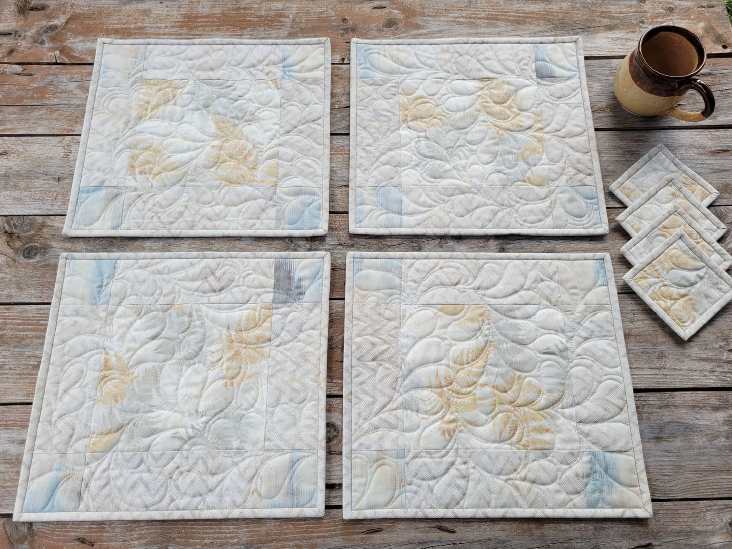 four quilted placemats with matching coasters