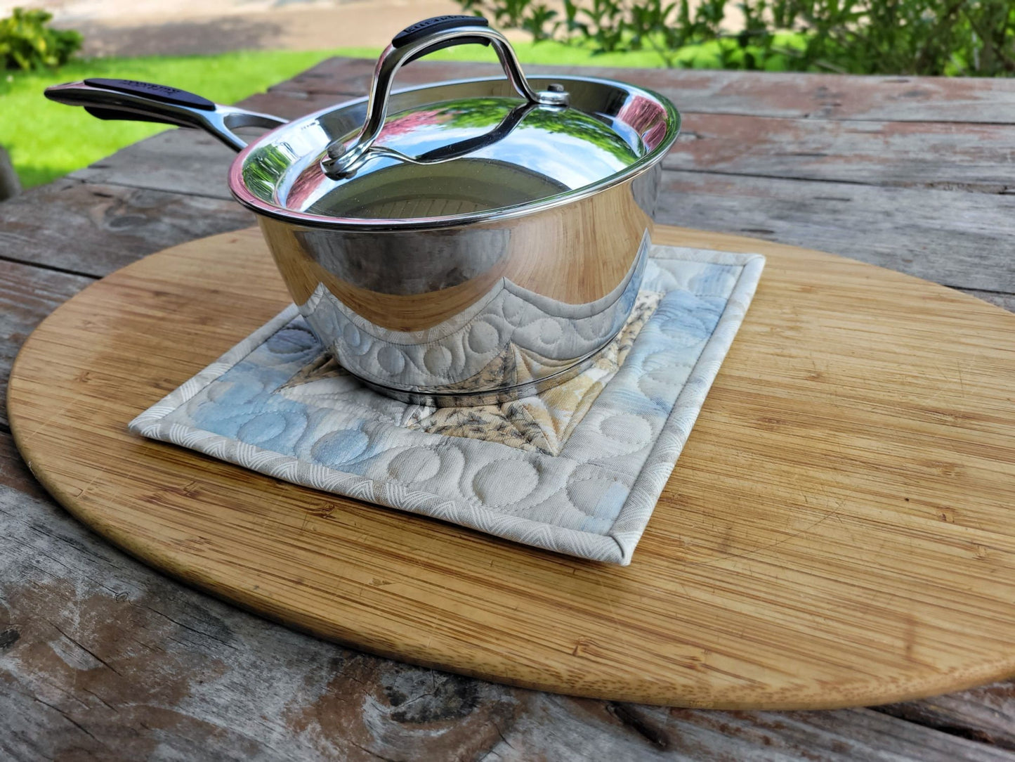 quilted potholder under a small size saucepan
