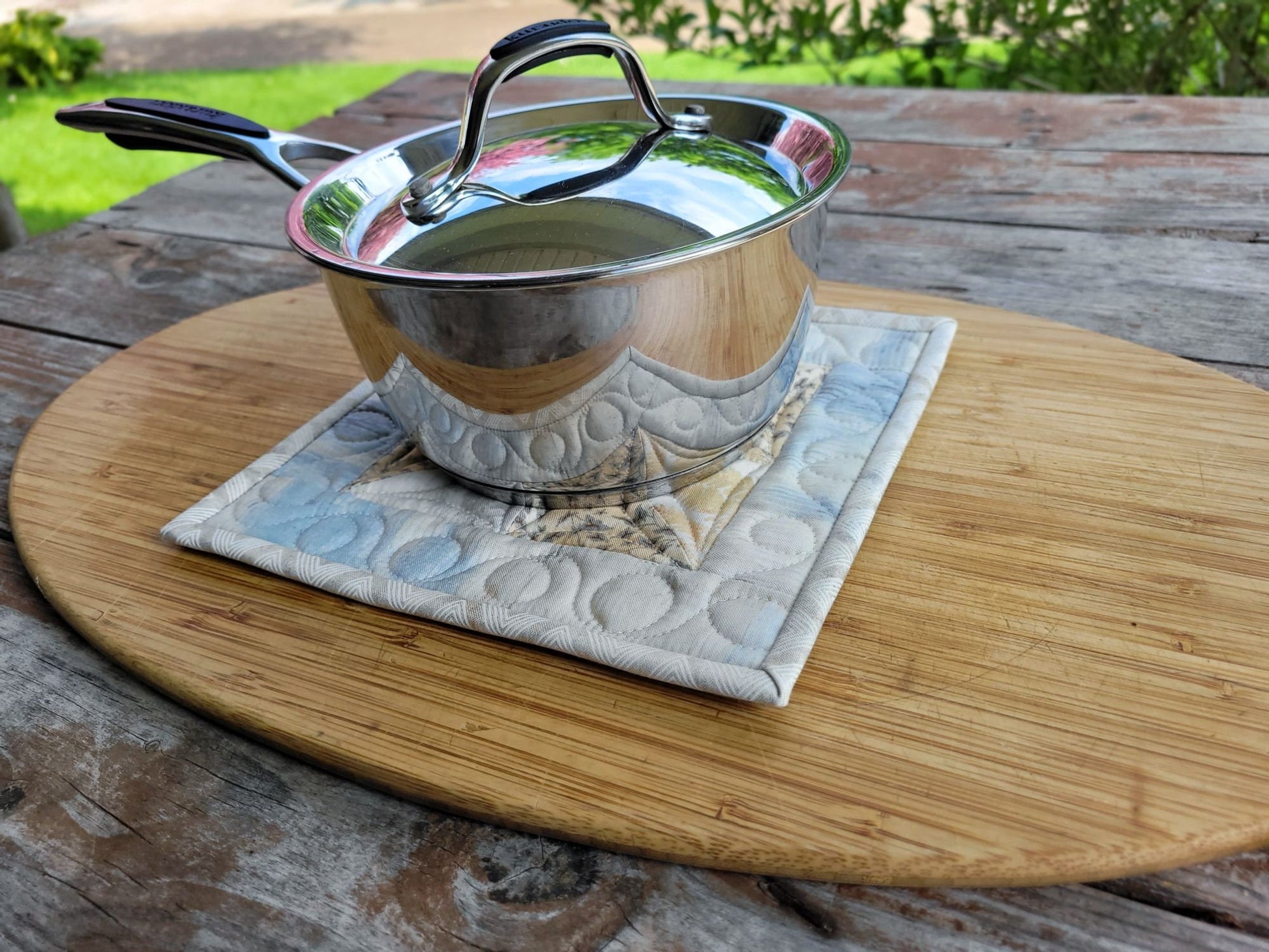 quilted potholder under a small size saucepan