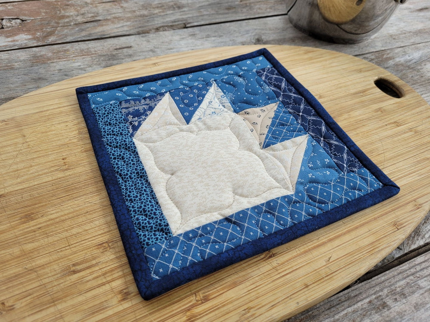 quilted potholder in blue bear paw design