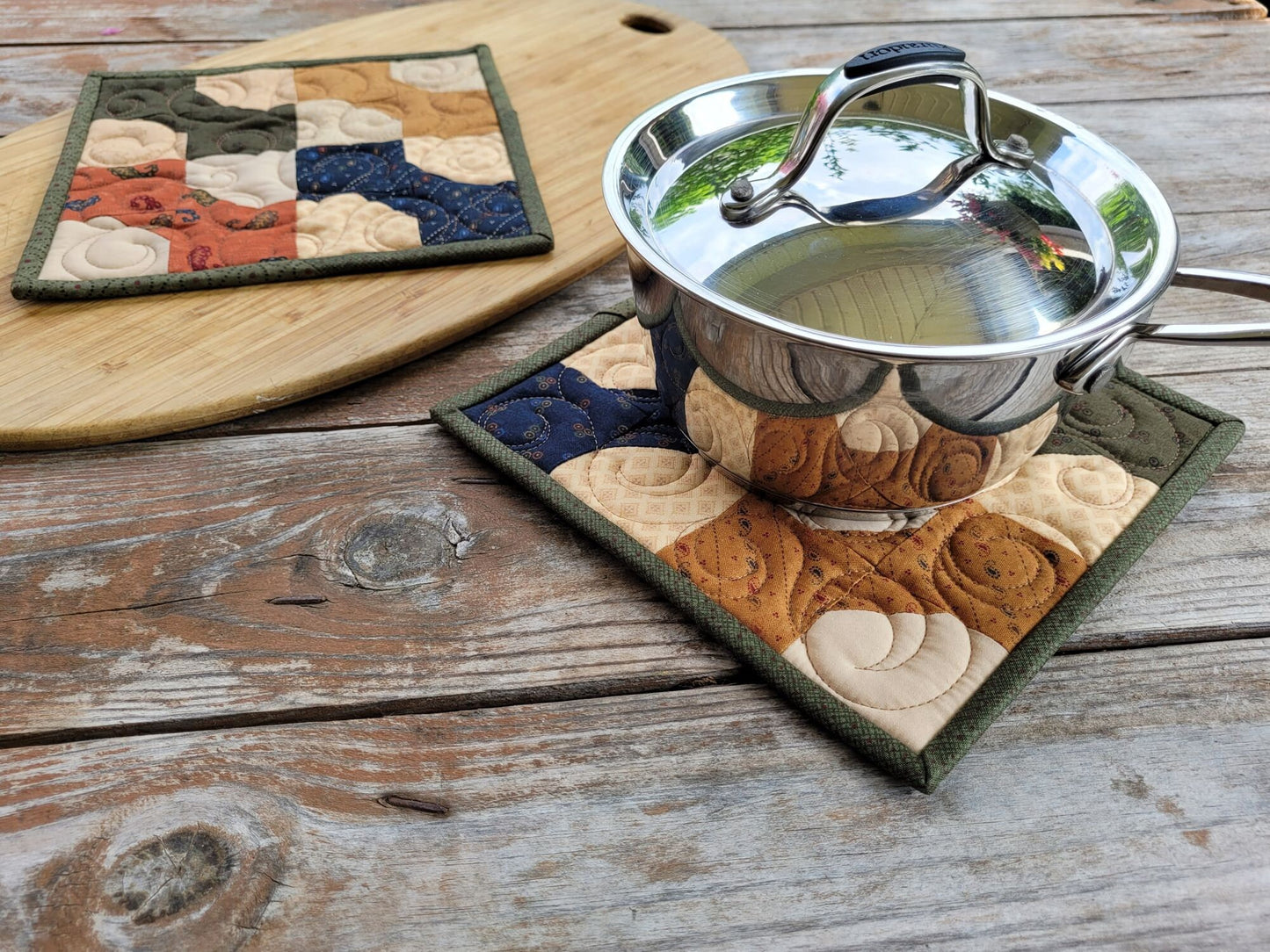 quilted hot mat under small size saucepan for scale