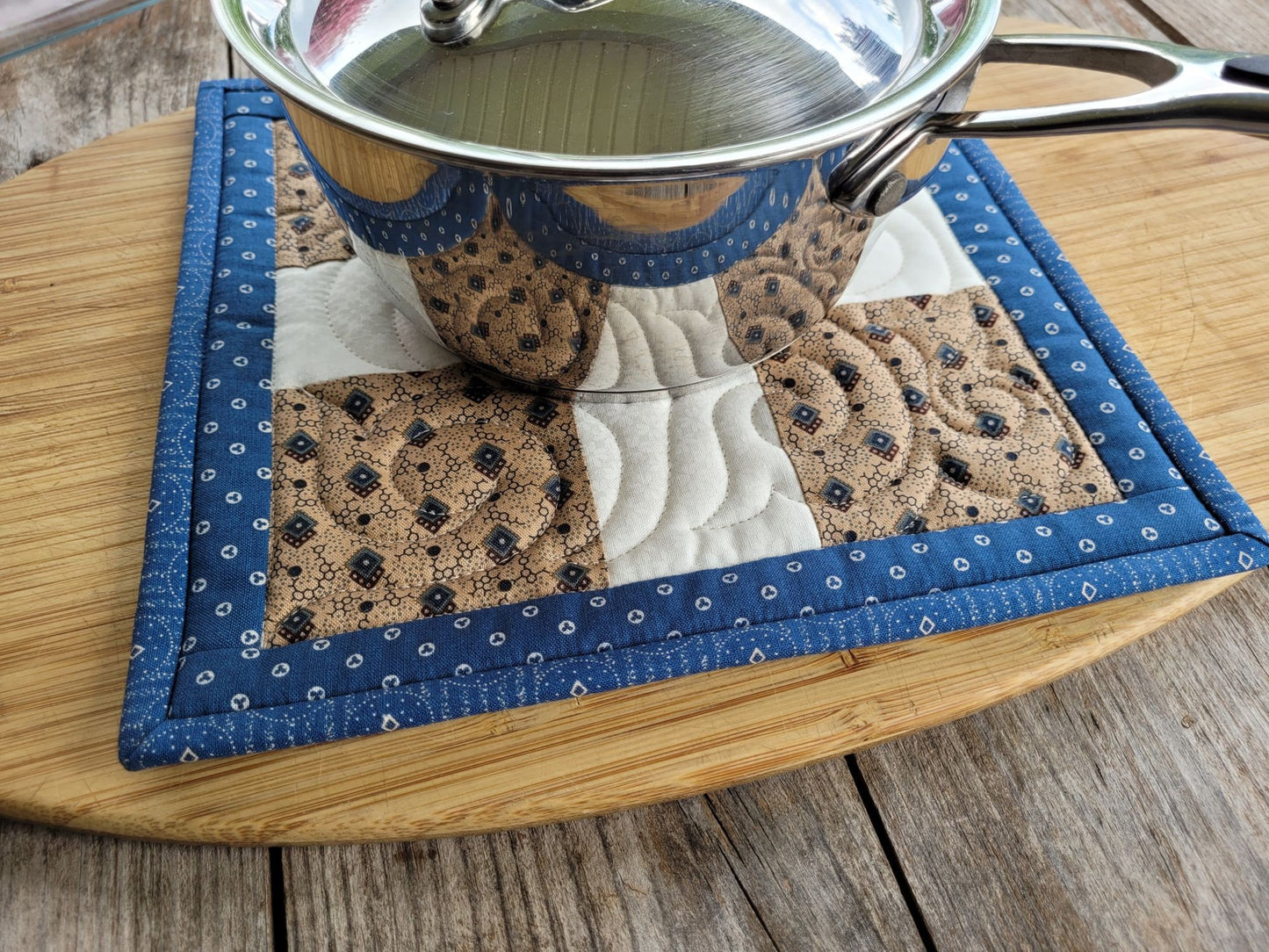 large quilted potholder under small size saucepan