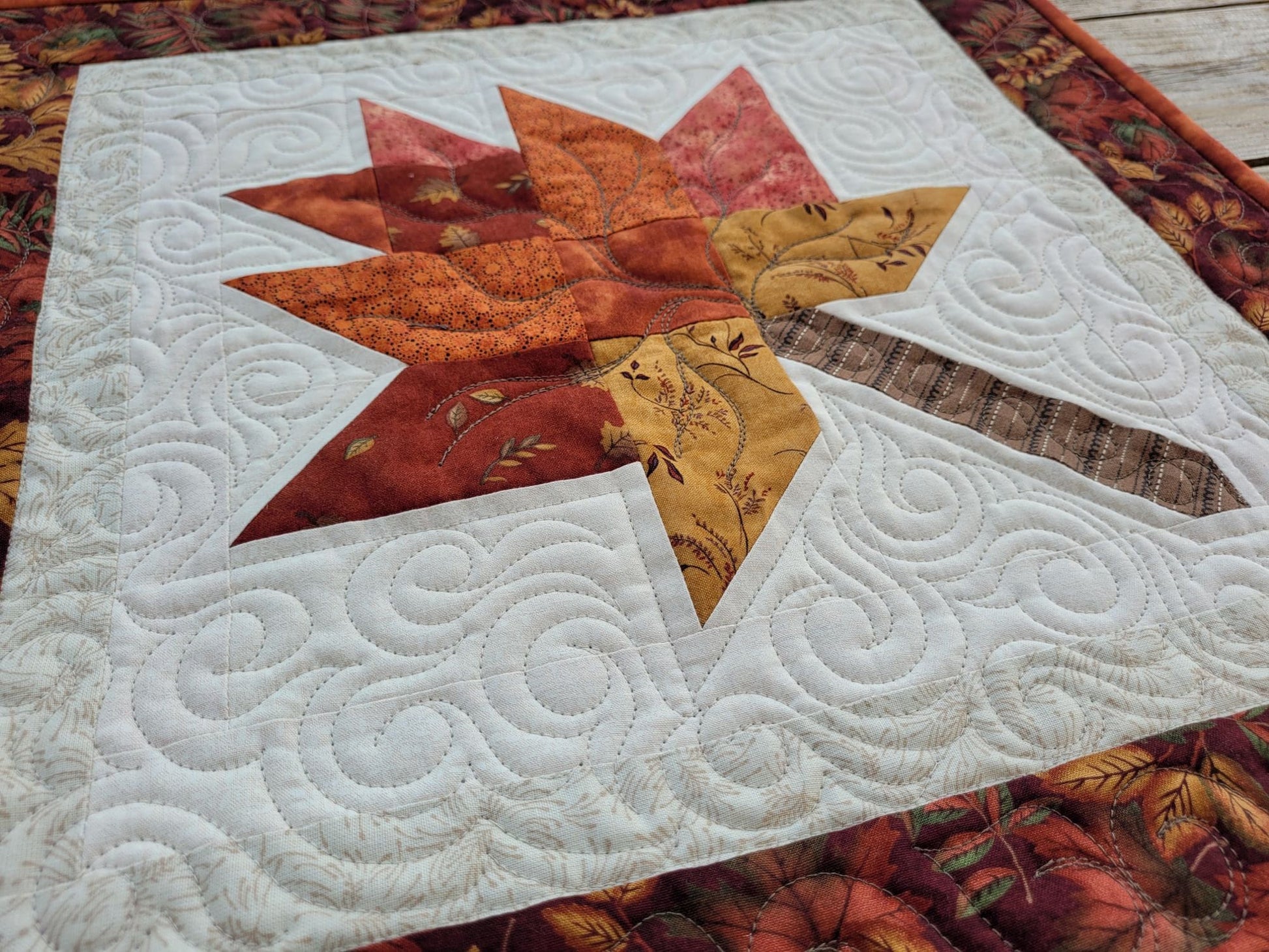 quilted table topper with fall leaf