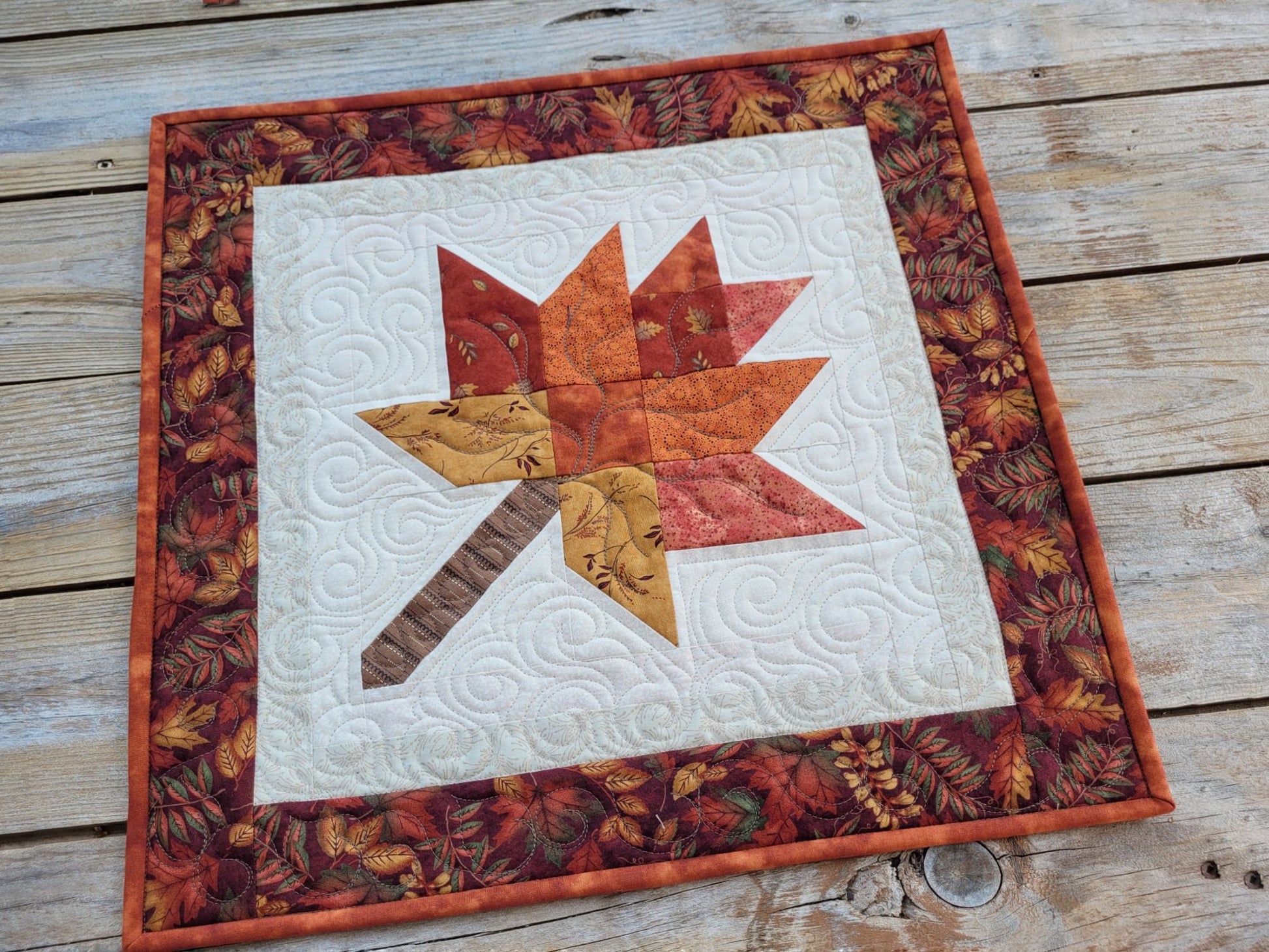 quilted table topper with fall leaf