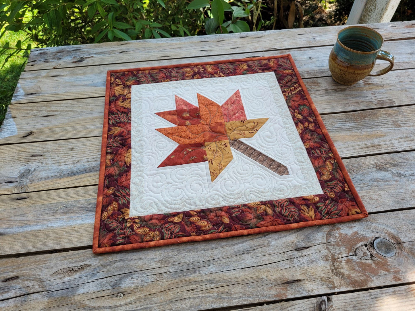 quilted table topper with fall leaf
