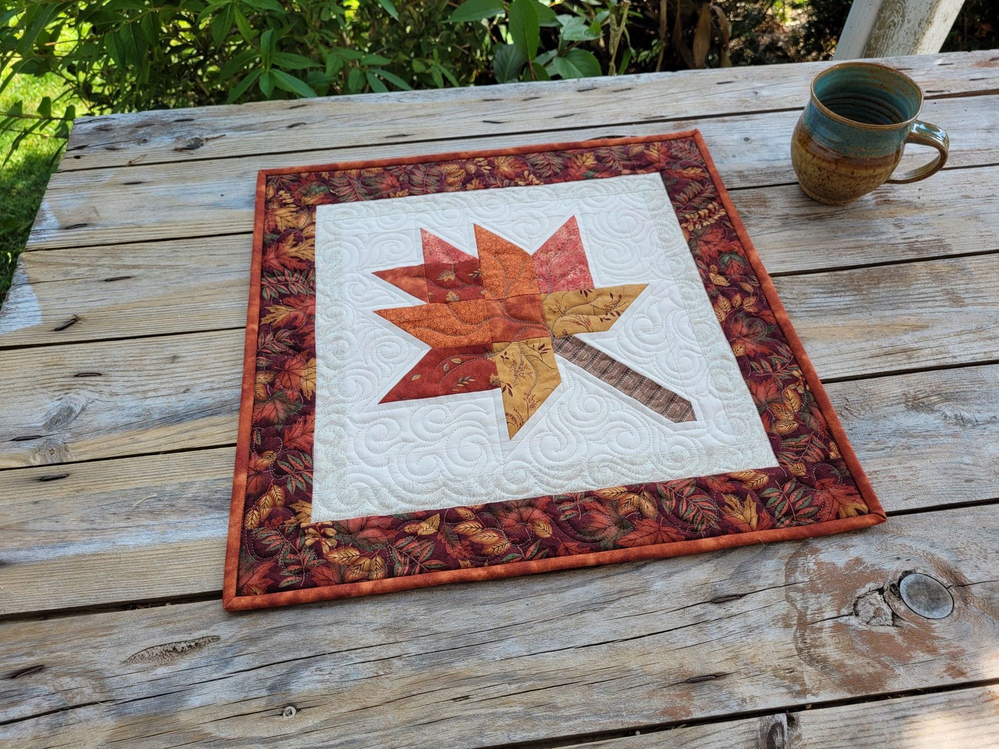 quilted table topper with fall leaf