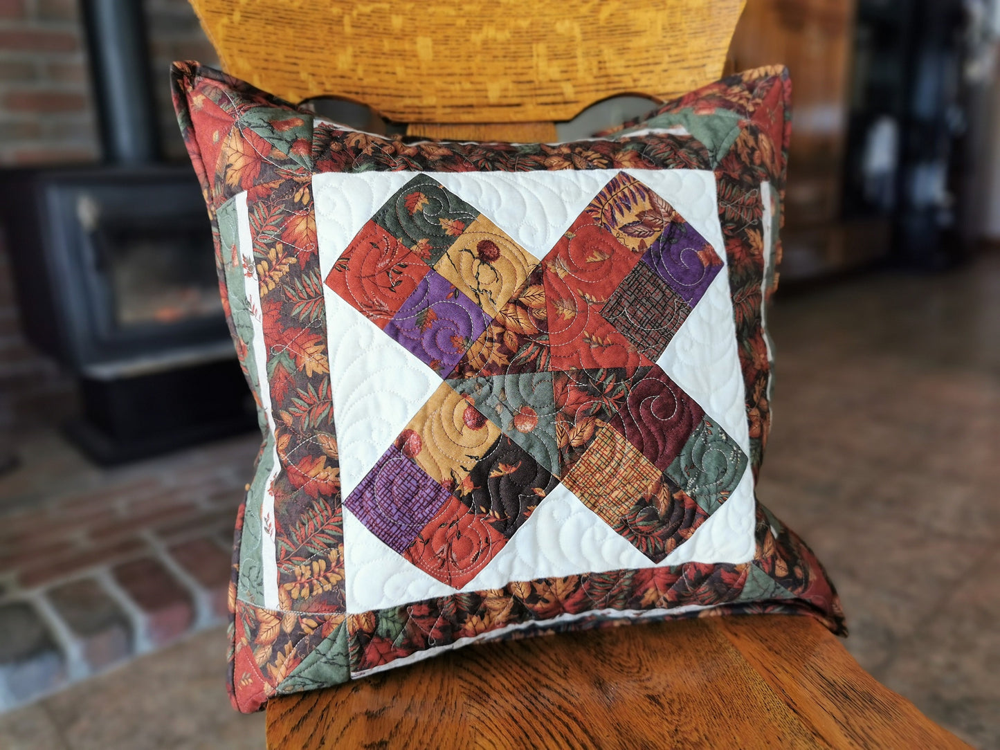 pillow sitting on a straight back wooden chair to show scale