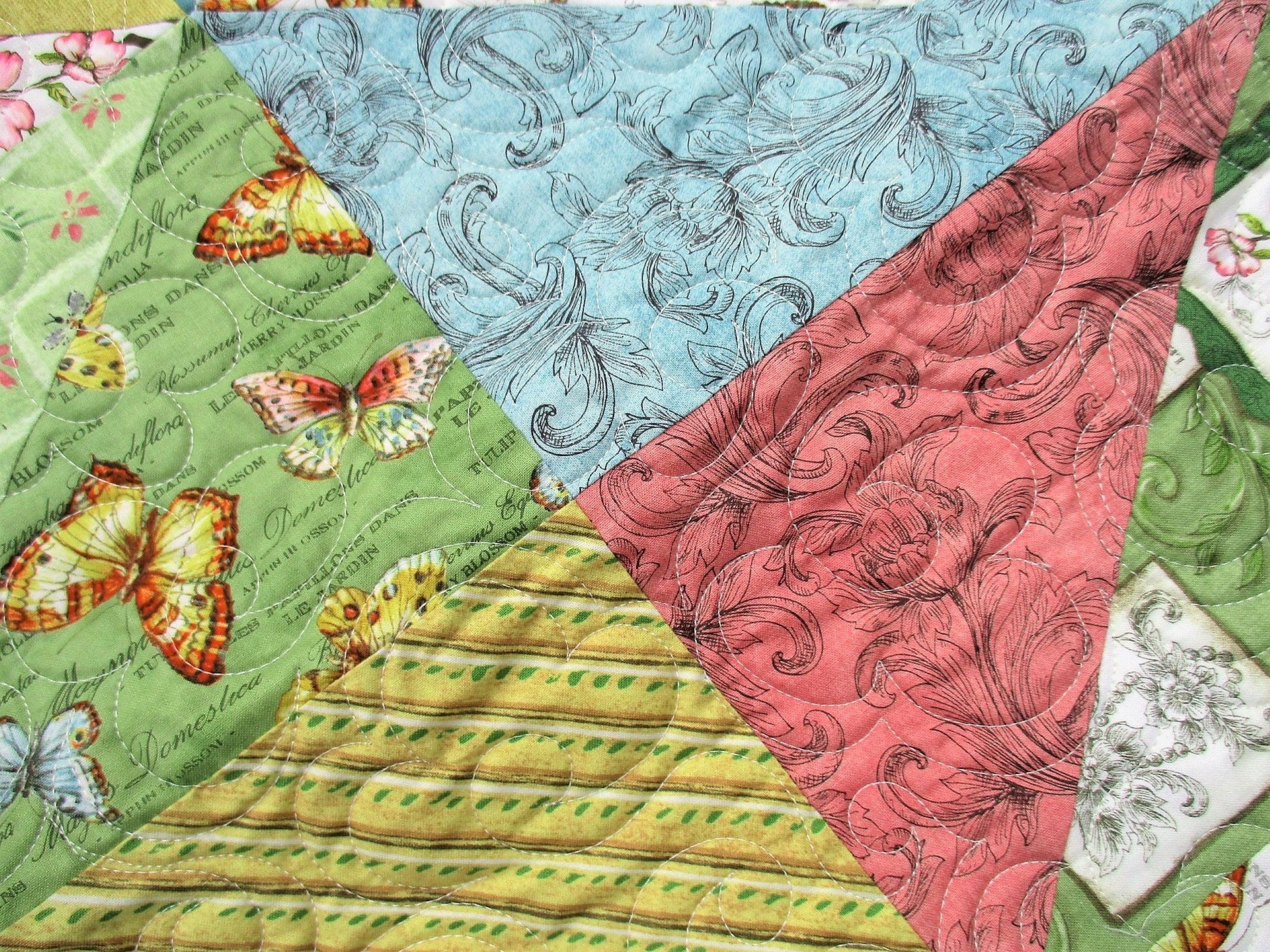 close up of butterfly fabric in spring throw quilt