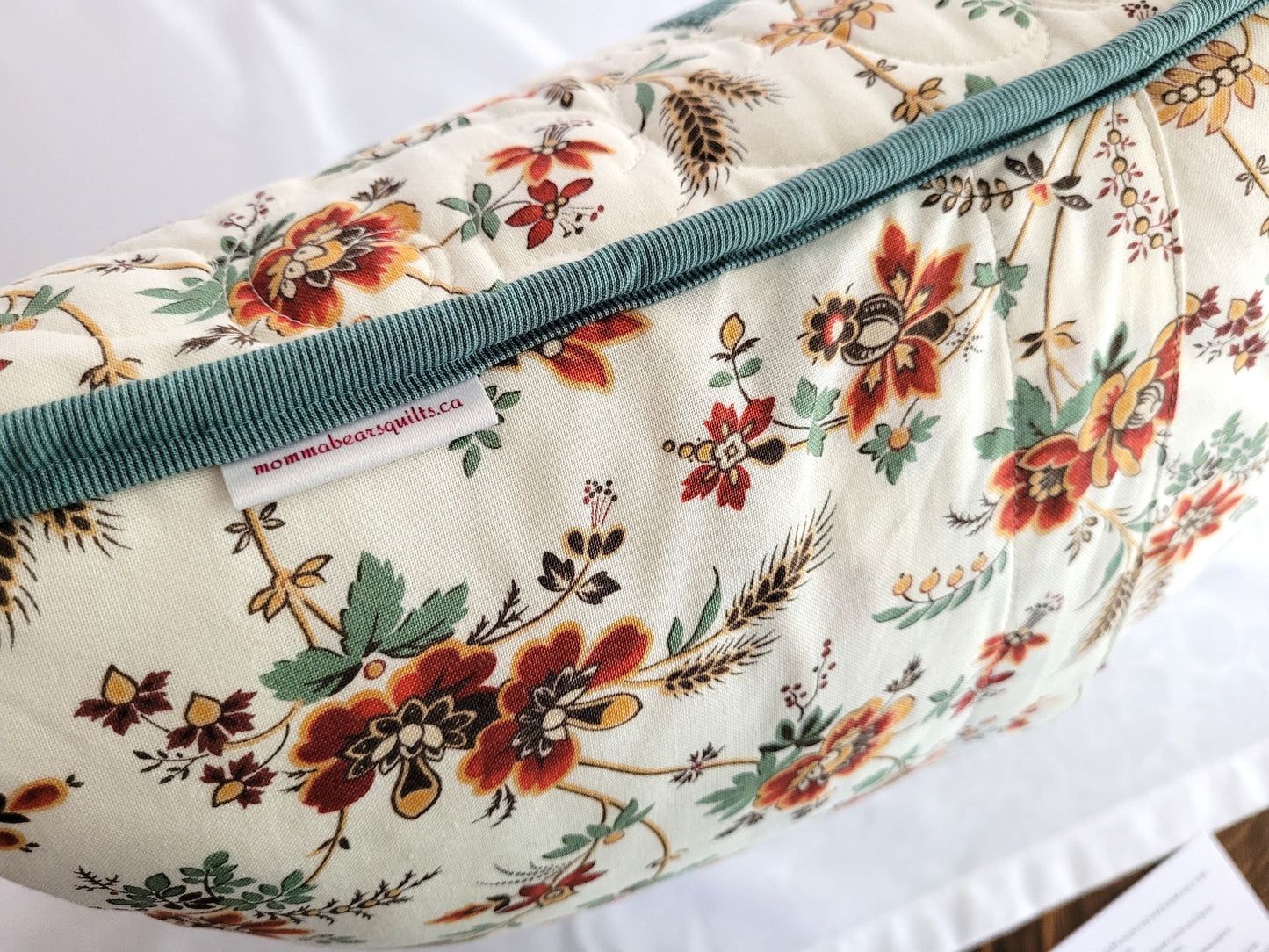 floral throw pillow with teal and white