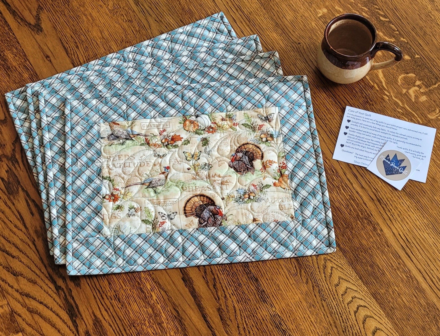 Quilted Thanksgiving placemats with pumpkins and turkeys.