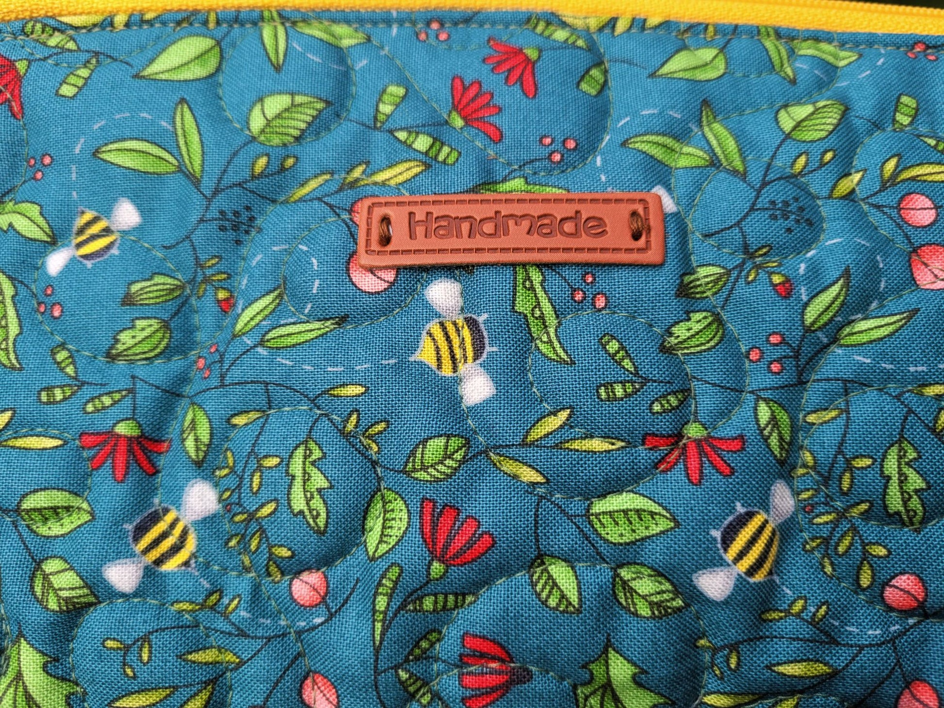 close up of bee fabric on large zipper pouch