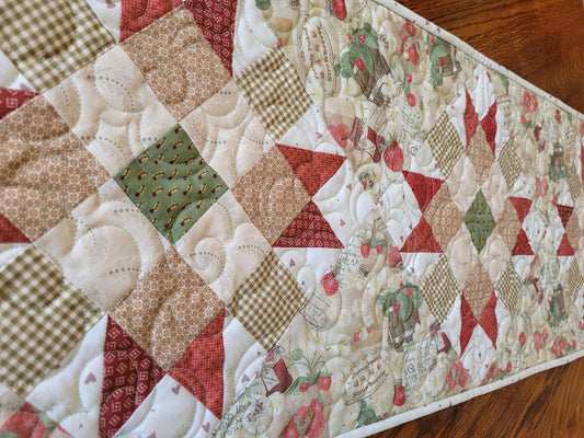 strawberry quilted table runner shown on angle view