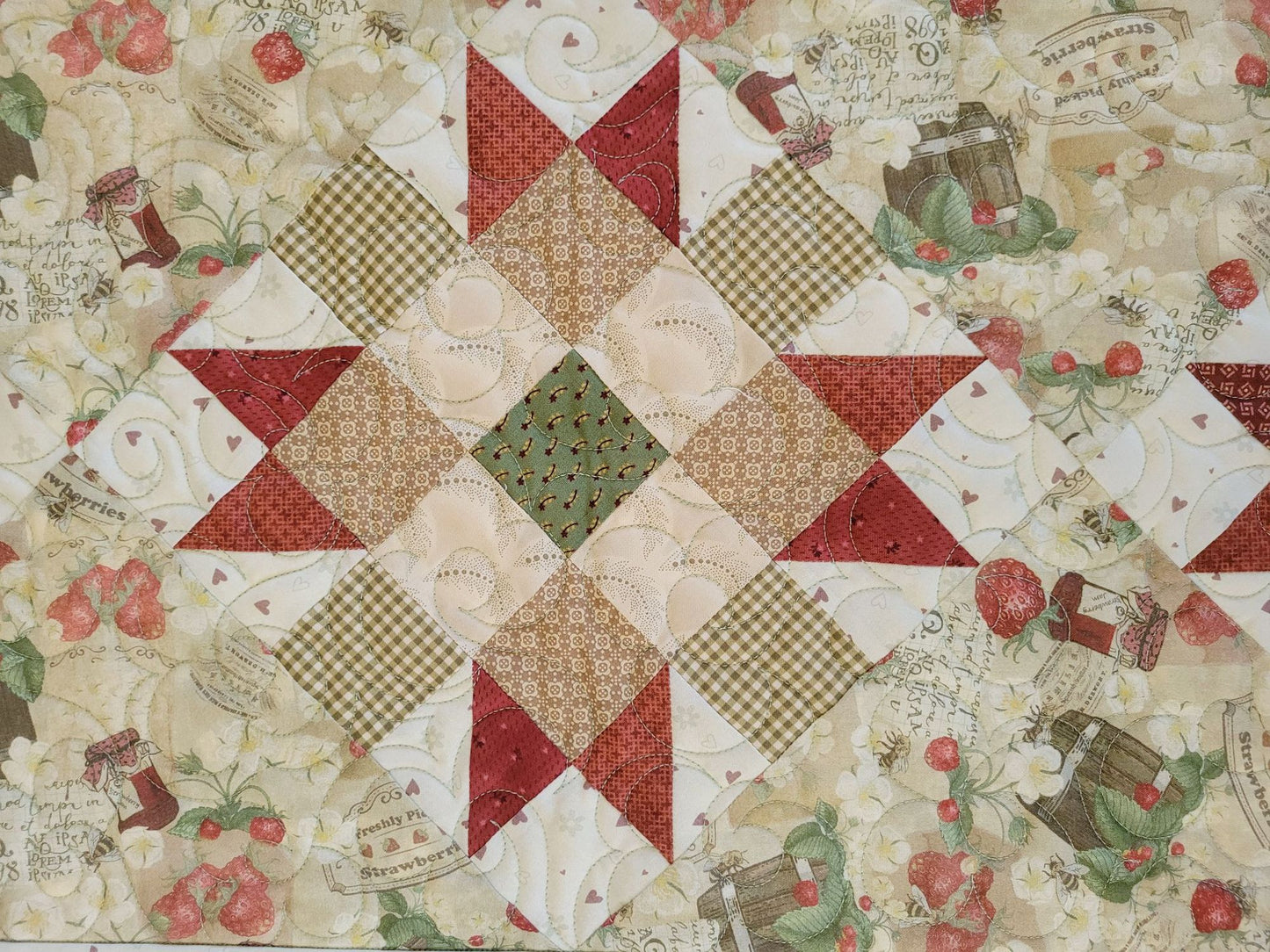 strawberry quilted table runner in close up of patchwork star block
