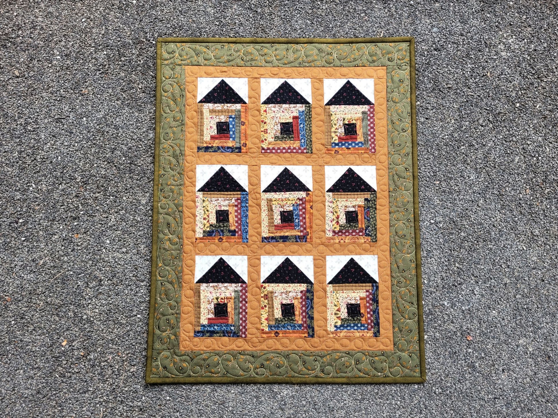 Quilt with house pattern on a textured surface