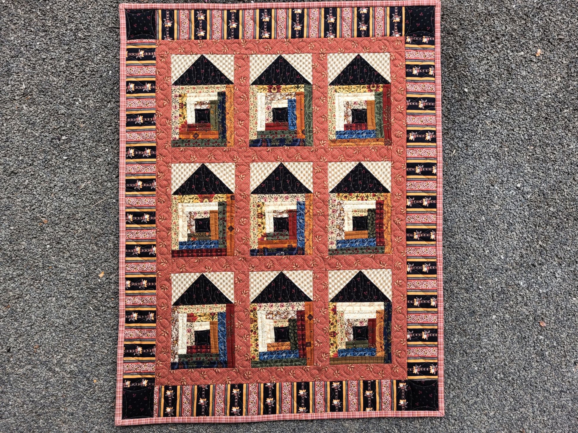 Quilt with house pattern on a textured surface