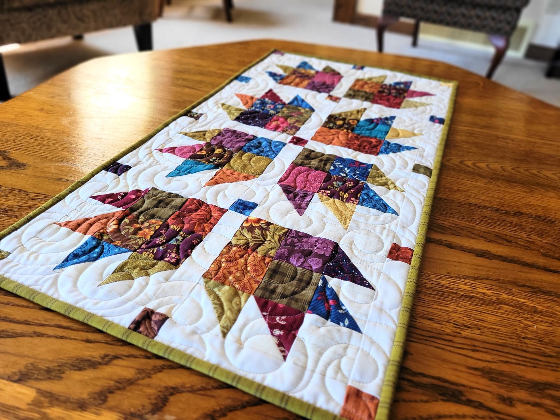 Colourful quilted table runner on a wooden table
