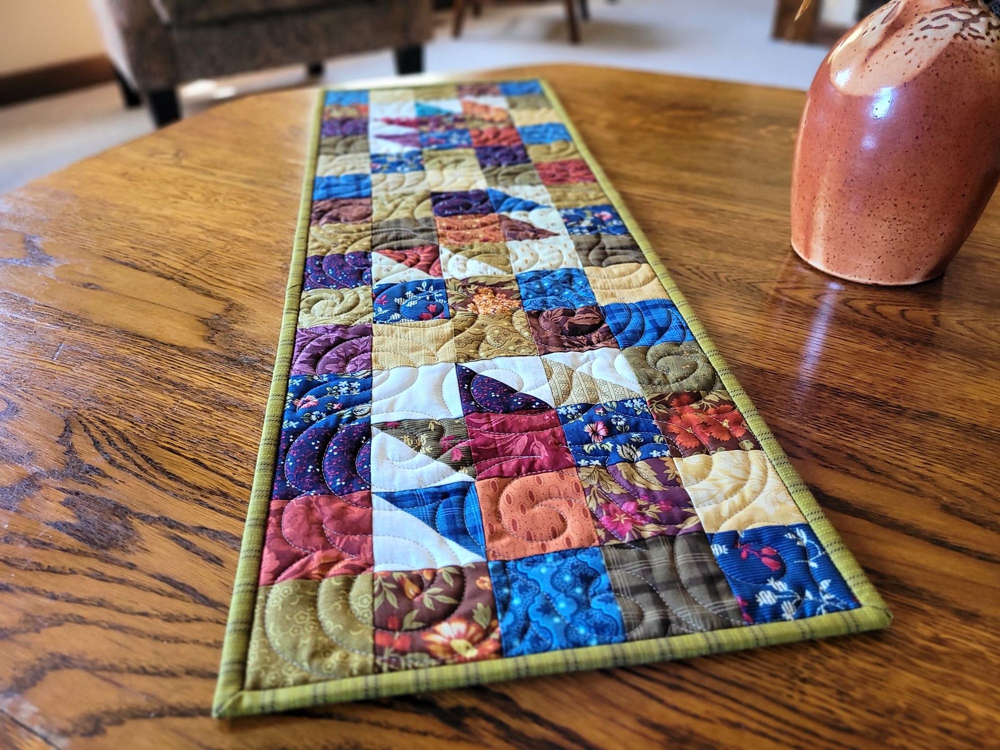 Colourful quilted table runner on a wooden table