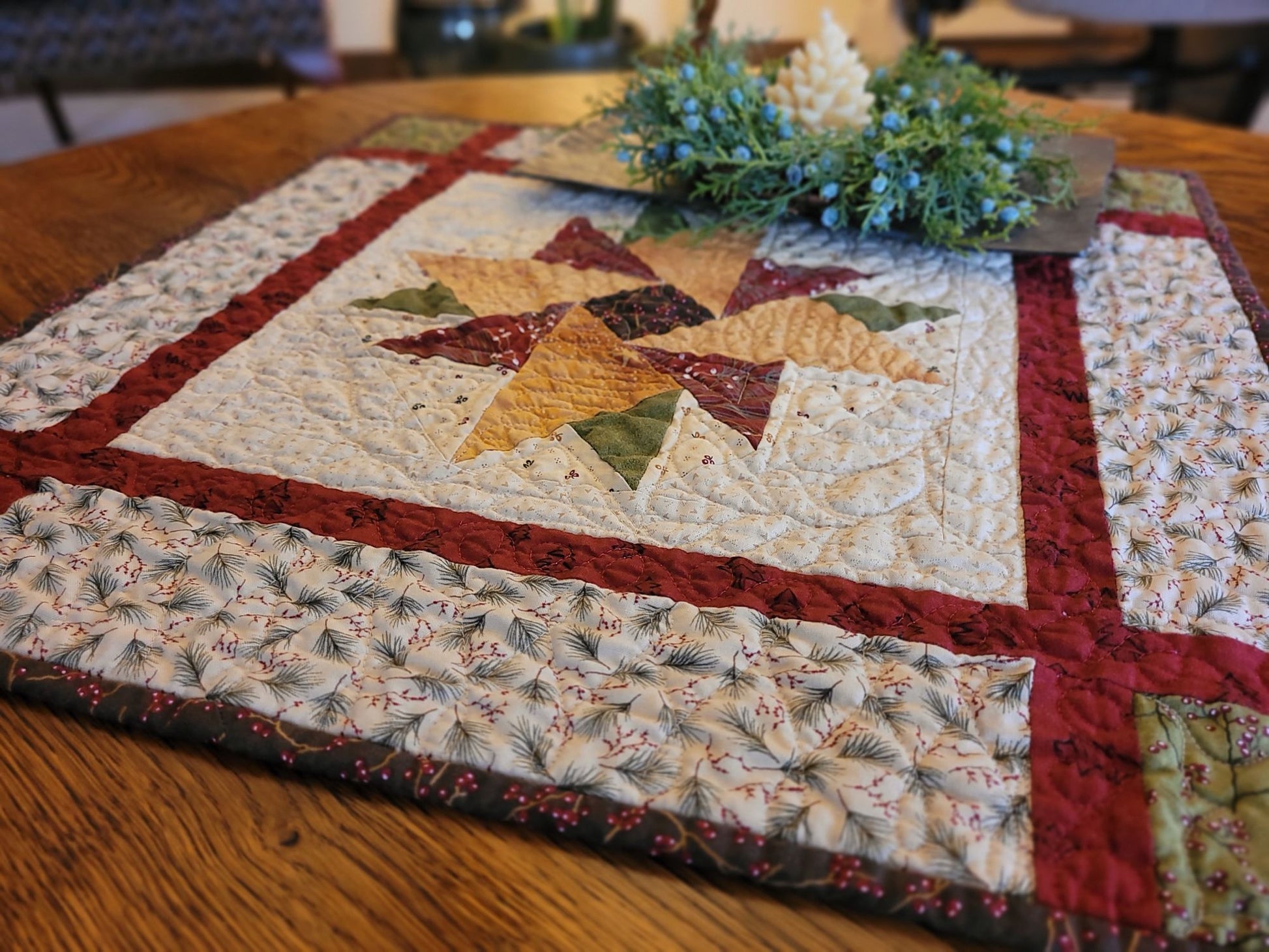 Quilted table runner with star pattern on a wooden table, angle view