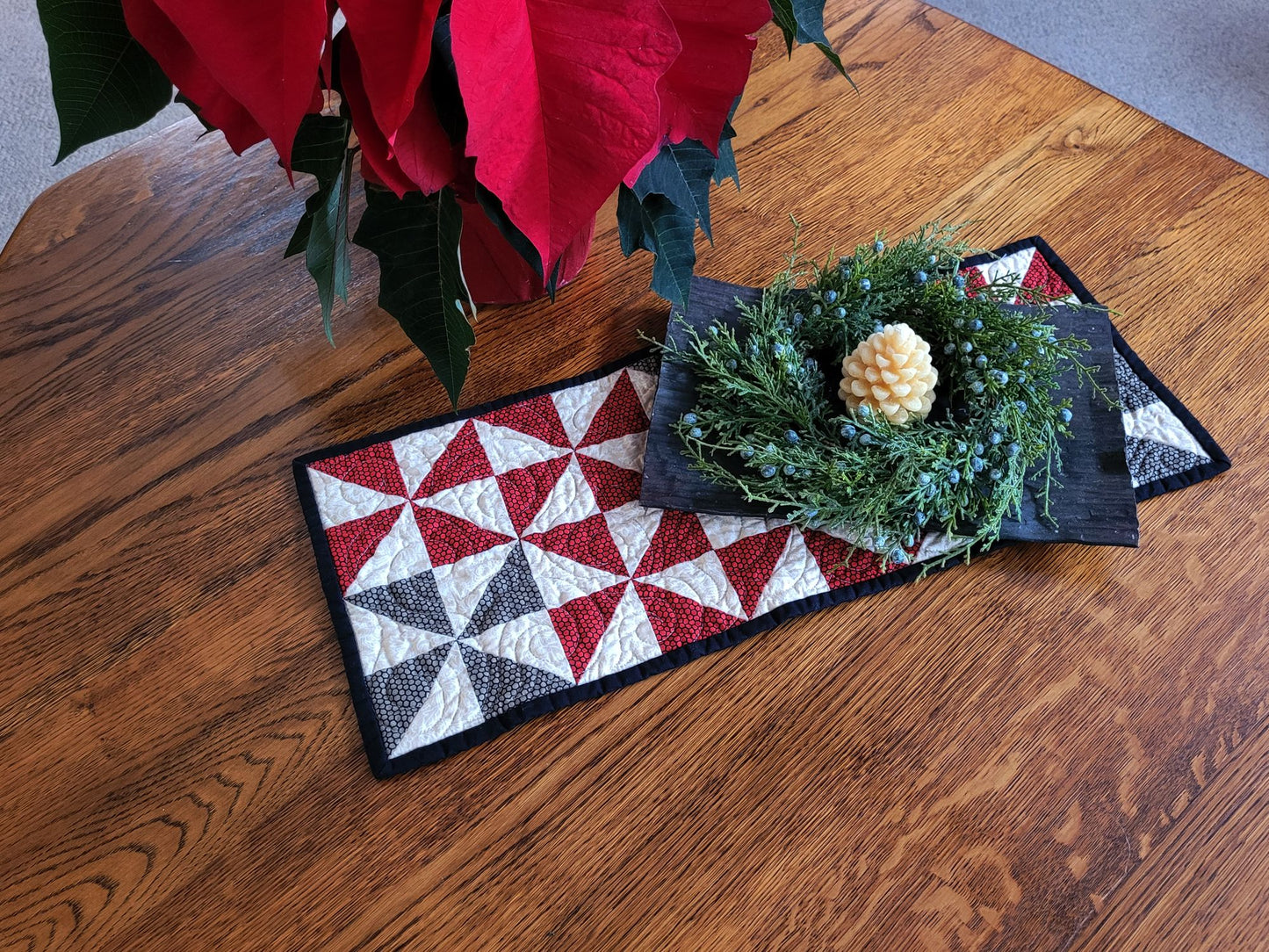 Decorative quilt with geometric pattern on a wooden surface