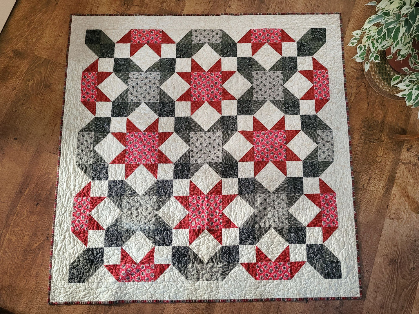 Quilt with star pattern on a wooden floor