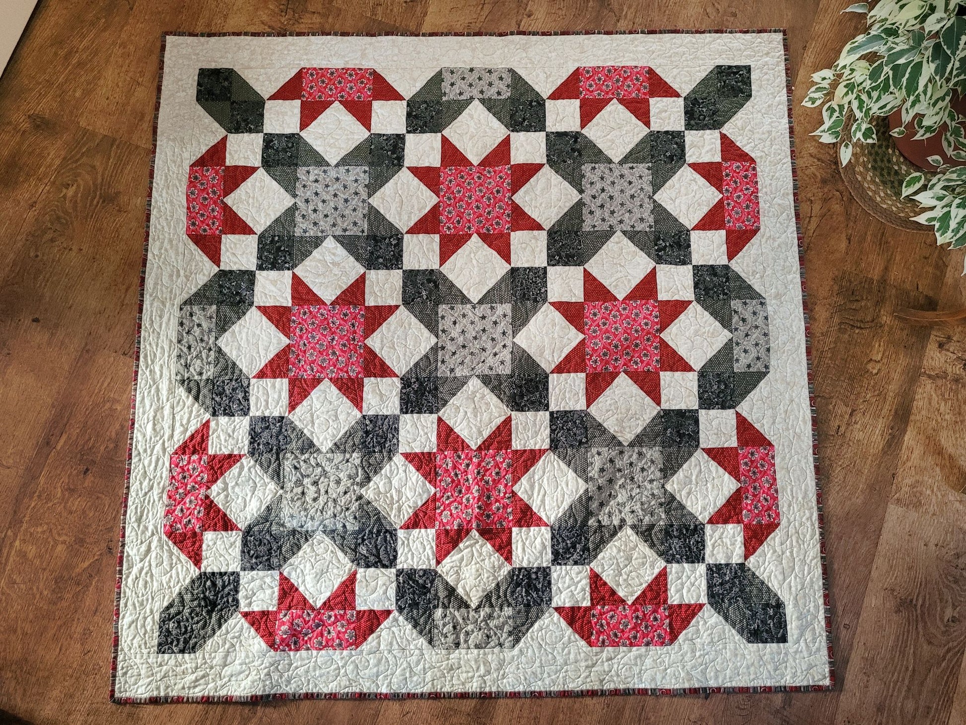 Quilt with star pattern on a wooden floor
