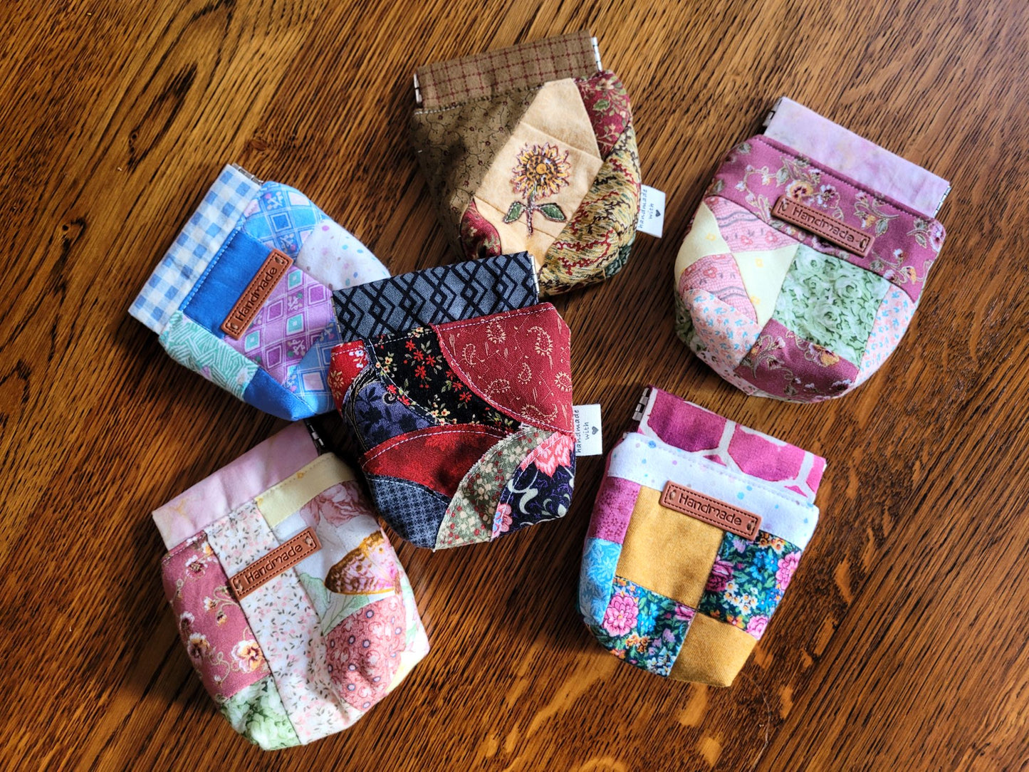 Collection of colorful fabric pouches on a wooden surface
