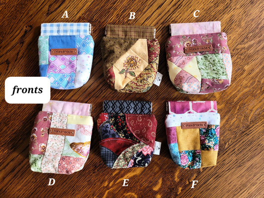 Collection of patchwork pouches labeled A to F on a wooden surface.