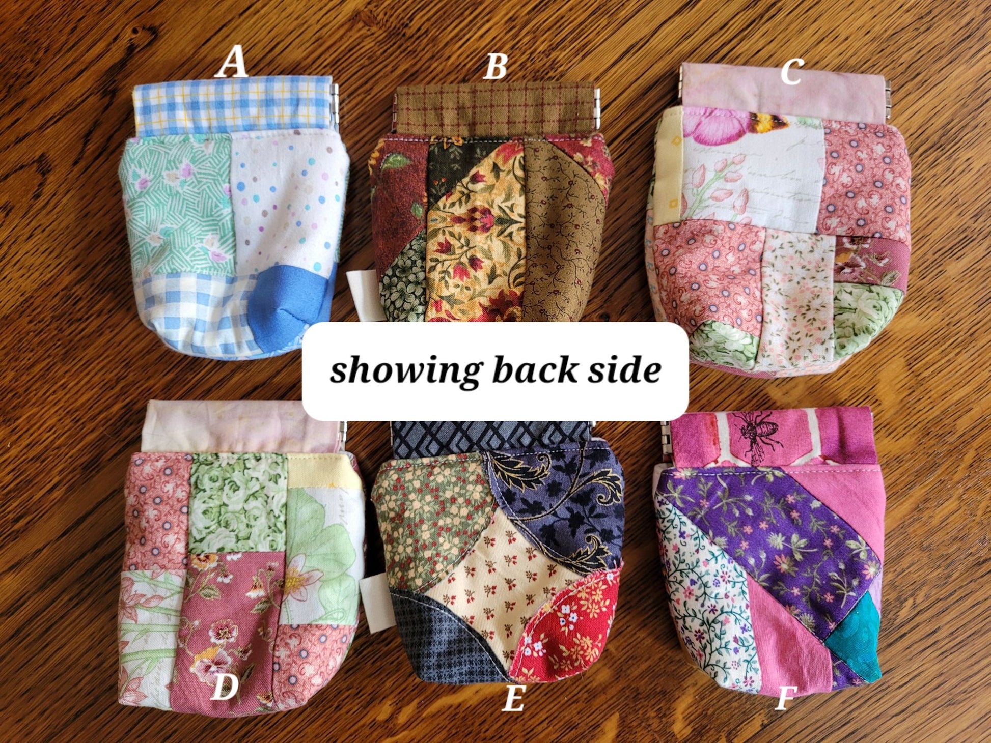 Patchwork pouches showing their back sides on a wooden surface