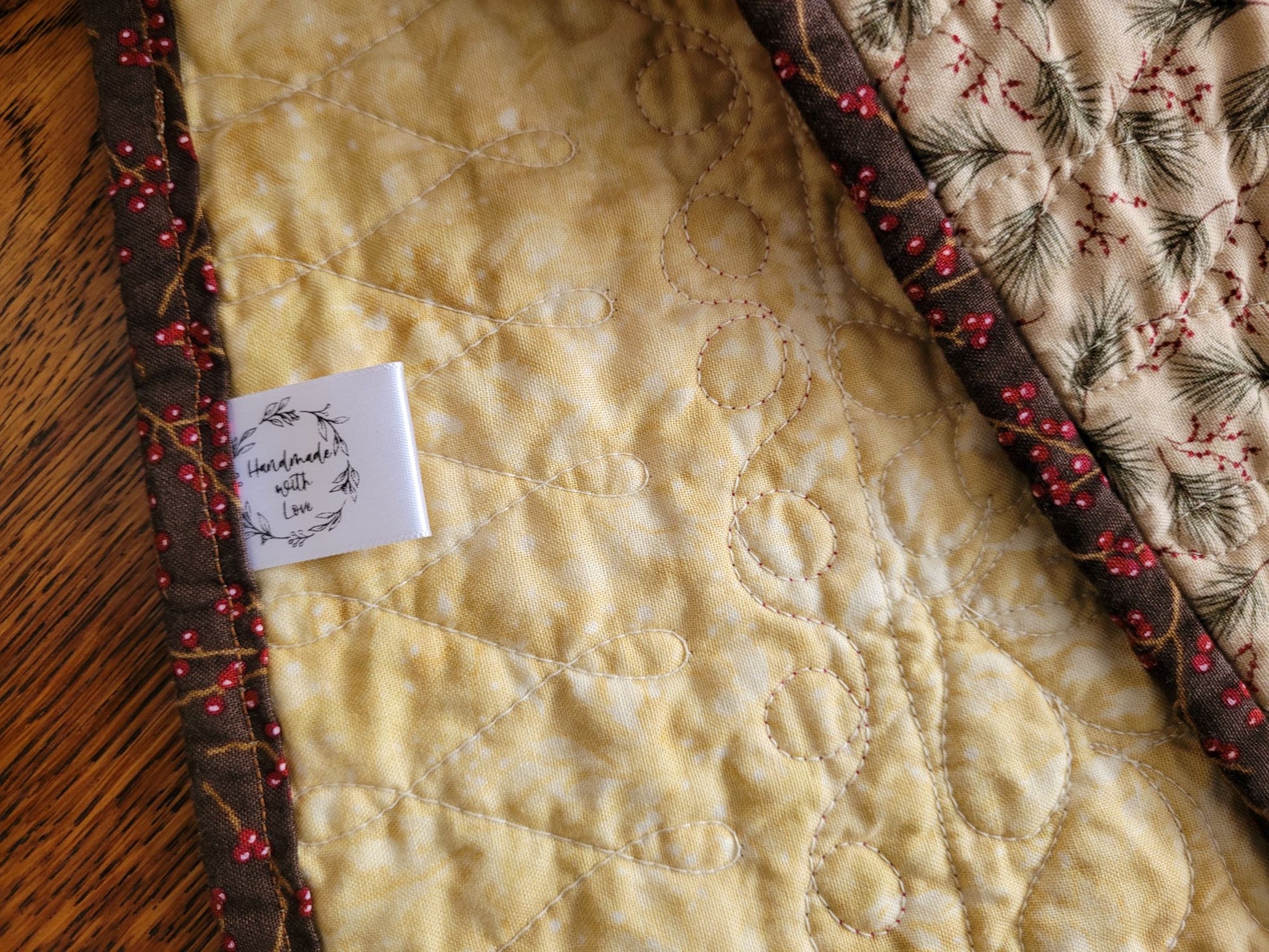 Showing back of quilt with a label on a wooden surface