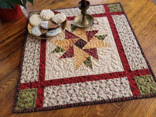 Quilted table runner with star pattern on a wooden surface