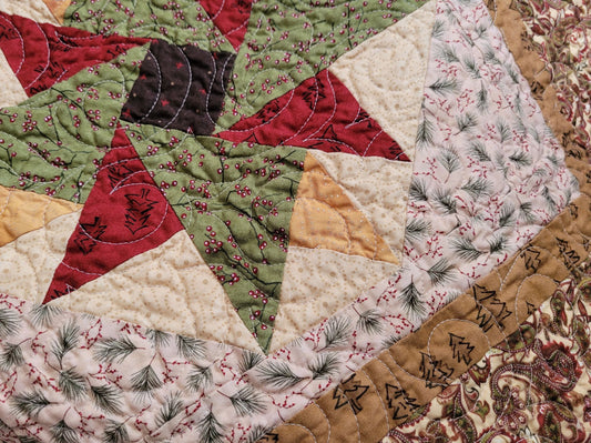 Close-up of a patchwork quilt with a Christmas Star pattern.