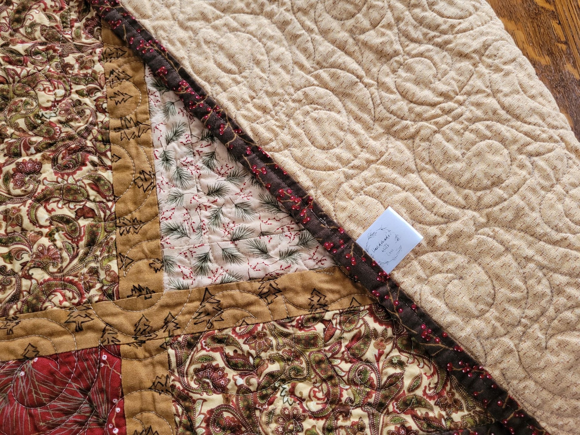 Showing back of quilt with a brand label.