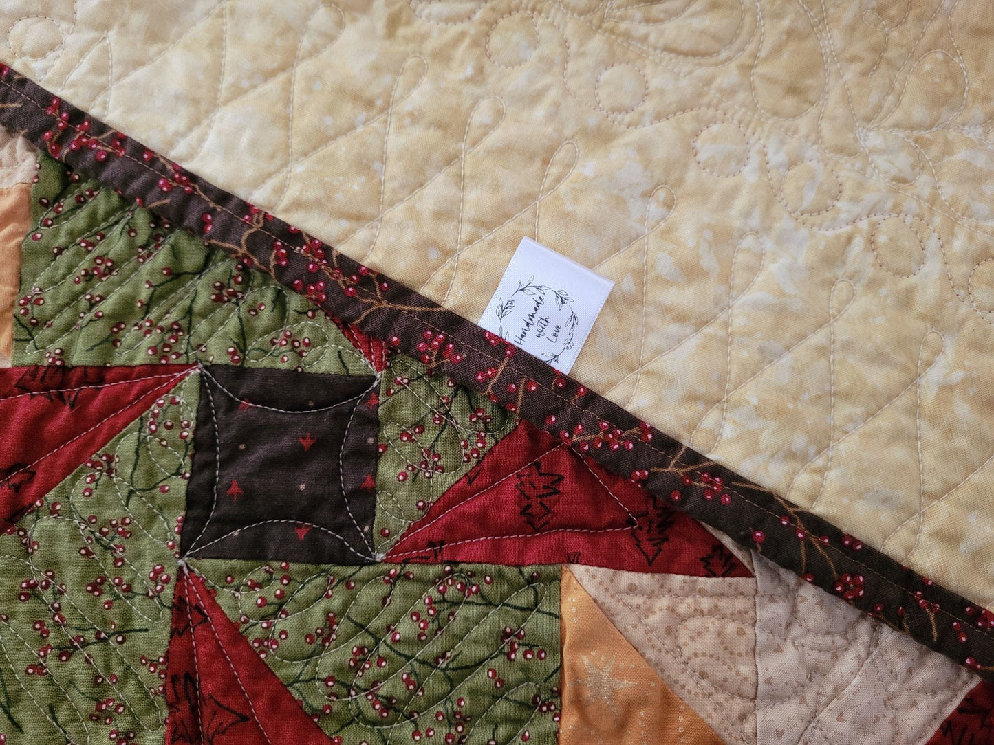 Showing back of a quilted table runner with a brand label.