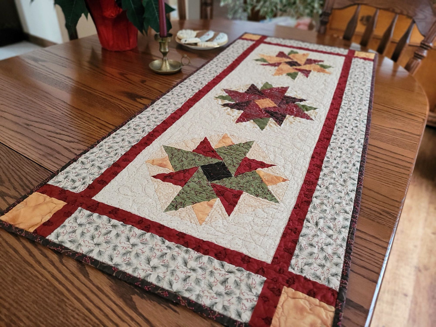 Quilted table runner with star patterns on a wooden dining table
